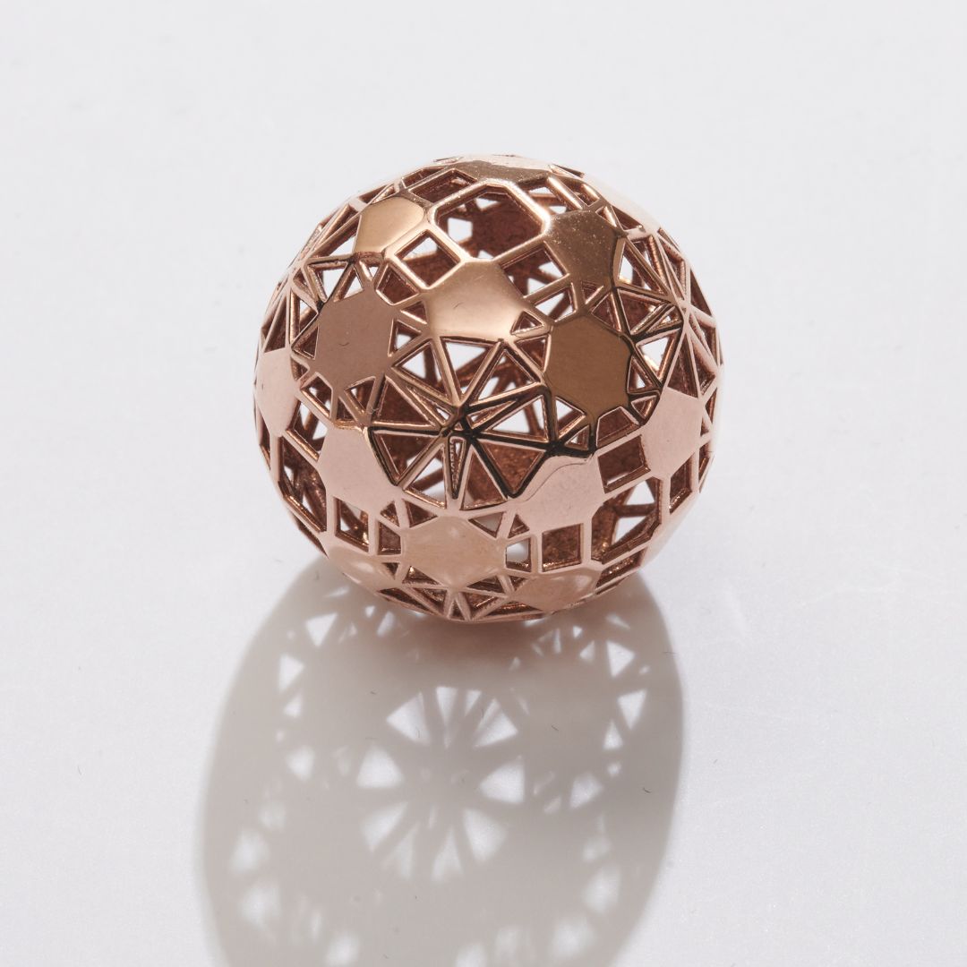 Polished spherical design in 14K rose gold plated brass