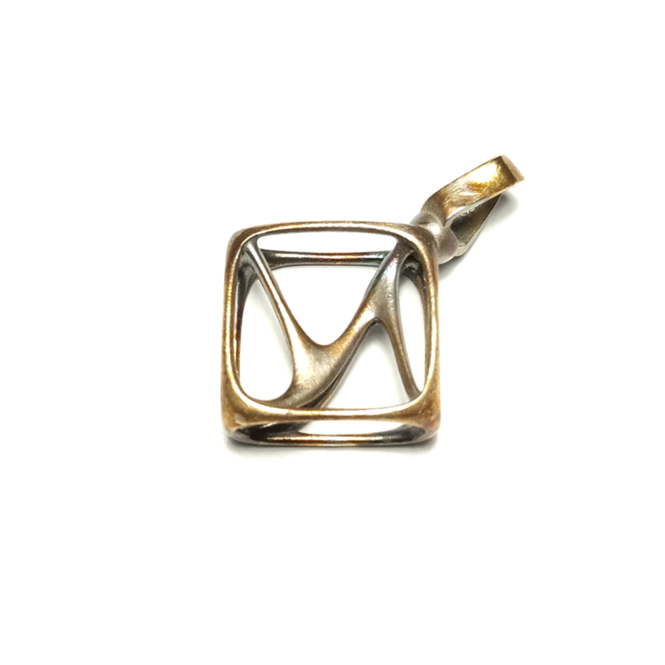 Square geometric bronze pendant with internal organic structure cast using lost wax casting